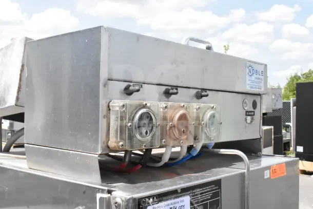 CMA AH-2 Commercial Straight Pass Through Dishwasher with visible control knobs and chemical compartments. Features Noble Chemical label.