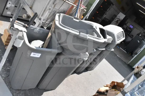 8 Toter gray poly trash cans, multiple sizes, durable construction, bid multiplier noted on visible label.