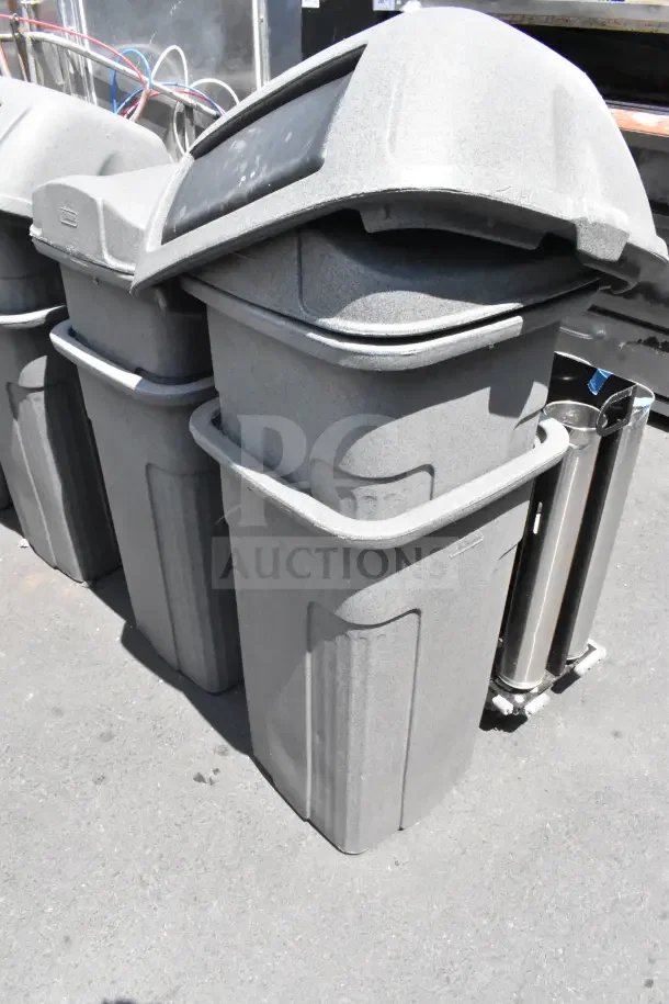 8 Toter gray poly trash cans with lids, durable construction, good condition. Auction includes 8 times your bid.