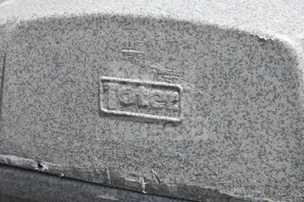 Toter gray poly trash can close-up, textured surface, embossed brand logo. Condition: visible wear. Auction: 8 times your bid.