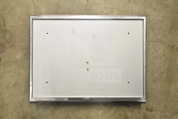 Stainless steel toilet seat cover dispenser, rectangular, with wall-mounting holes; condition unclear.