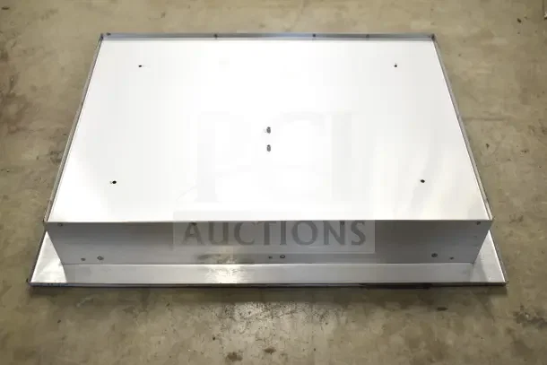 Stainless steel toilet seat cover dispenser, rectangular, with mounting holes, shown in used condition.