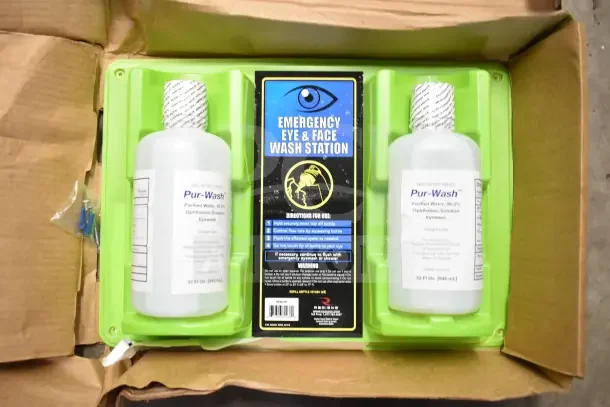 Emergency Eye & Face Wash Station with two Pur-Wash bottles, 32 fl oz each, in green holder. Instructions visible. New condition.