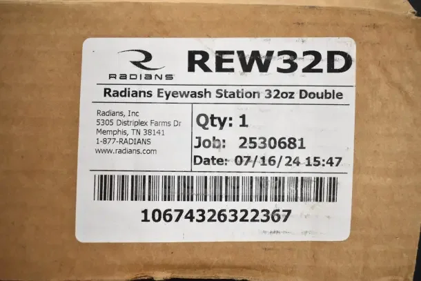 Radians Emergency Eye & Face Wash Station, model REW32D, 32oz double, in packaging. Label includes job number and date.