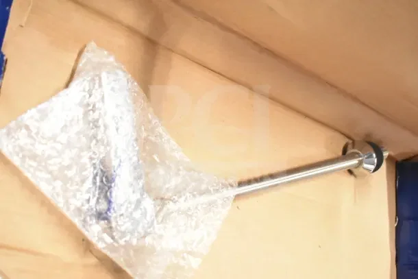 Brand new Encore Water Dispenser in box, wrapped in bubble wrap, featuring a sleek metal dispenser tube.
