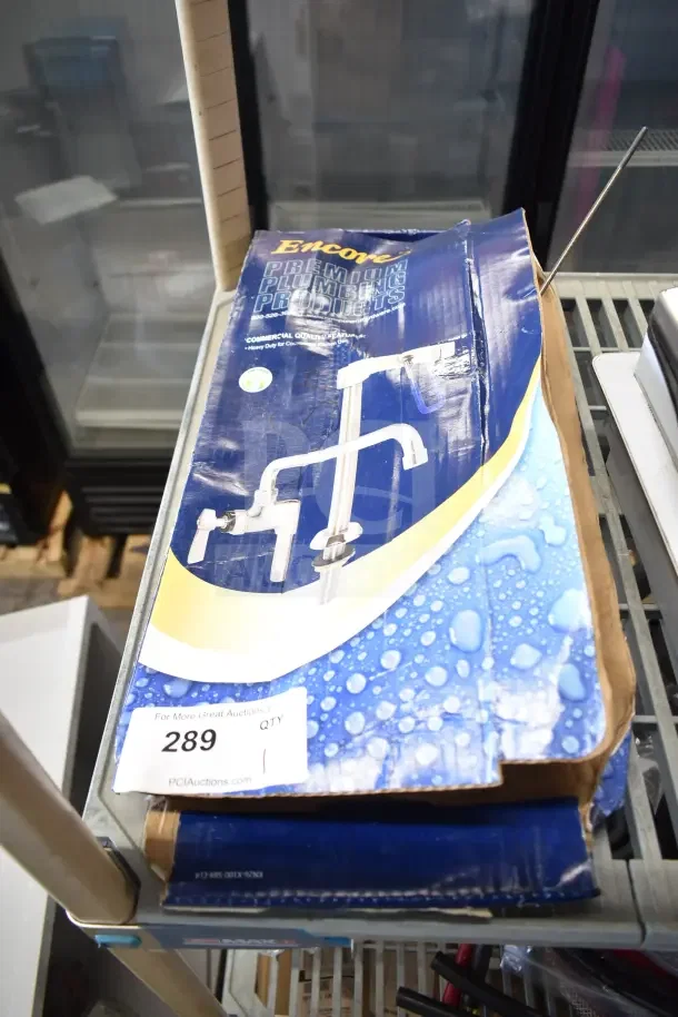 Brand new Encore water dispenser in box, blue packaging with product image, labeled for premium plumbing.