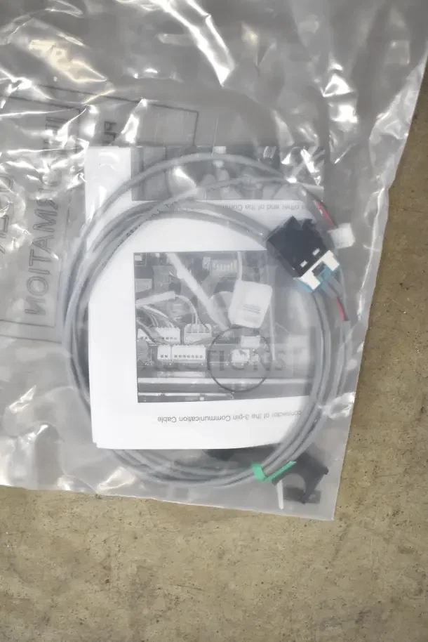 Bag containing new communication cable set with attached connector and instruction sheet.
