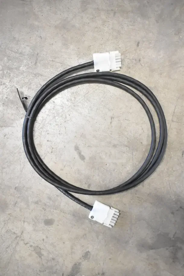 Coiled black hose with white connectors on concrete floor. Brand new condition. Part of a set of 18 items including thermometers.