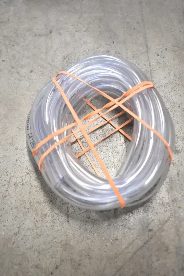 Coiled clear hose, new and bundled with orange ties, part of 18 brand new items including storage thermometer.