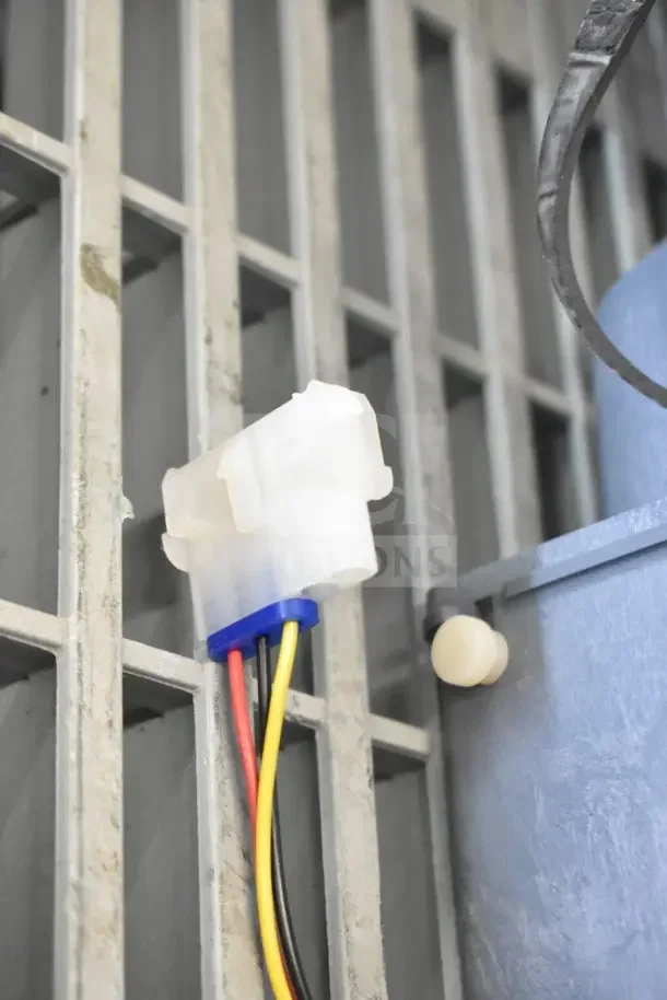 New electrical connector with yellow, red, black wires attached to a metal rack. Part of a lot including a soap dispenser and bin kit.