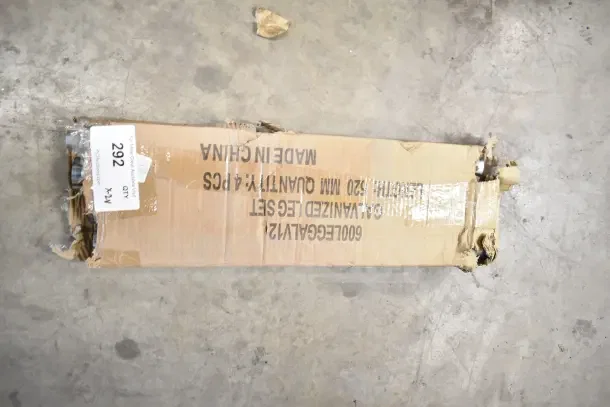 Damaged cardboard box showing "600GALVANIZED LEGS SET" and "MADE IN CHINA," containing shelving brackets and legs.