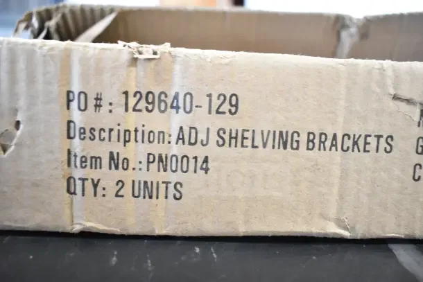 Cardboard box with printed label: "PO#: 129640-129, Description: ADJ SHELVING BRACKETS, Item No.: PN0014, QTY: 2 UNITS."