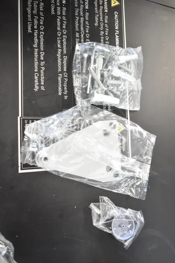 Brand new Falcon SC81A door closer with installation hardware, in original packaging, showing screws and metal components.