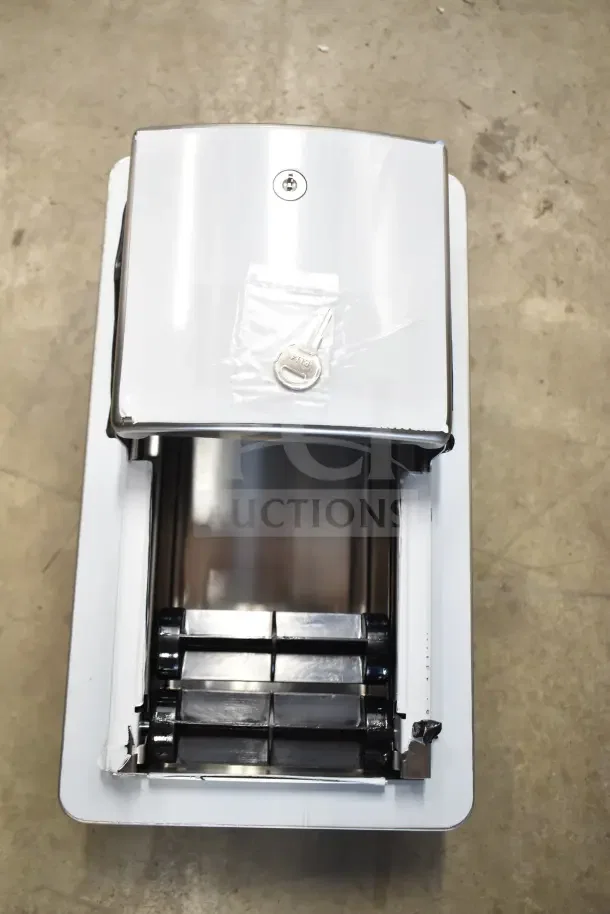 Brand new Roval 10-20031 toilet tissue dispenser, metal finish, with key in packaging, mounted on a white box.