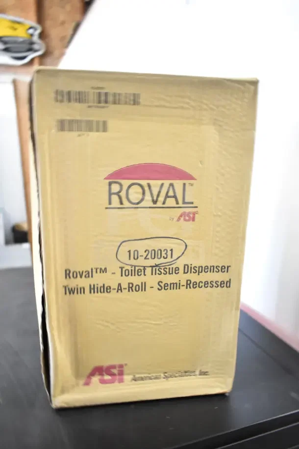Box with Roval 10-20031 toilet tissue dispenser. Brand new, semi-recessed twin hide-a-roll model by ASI.