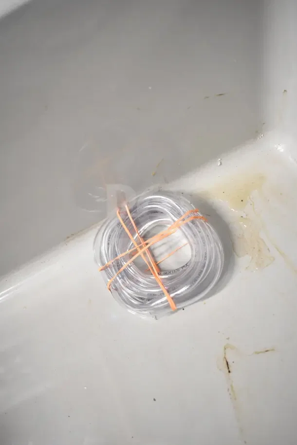 Brand new Poly Mop Sink in box, features durable material, includes coiled tubing, pristine condition.
