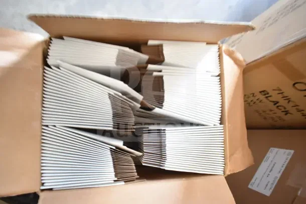 Three boxes of brand new Oliver Tuck Top Boxes, showing minor dents, stacked in open shipping box.