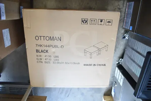 Cardboard box labeled "Ottoman, 7HK144PUBL-D, Black," showing dimensions 33x31.5x13.5 inches, partially dented.