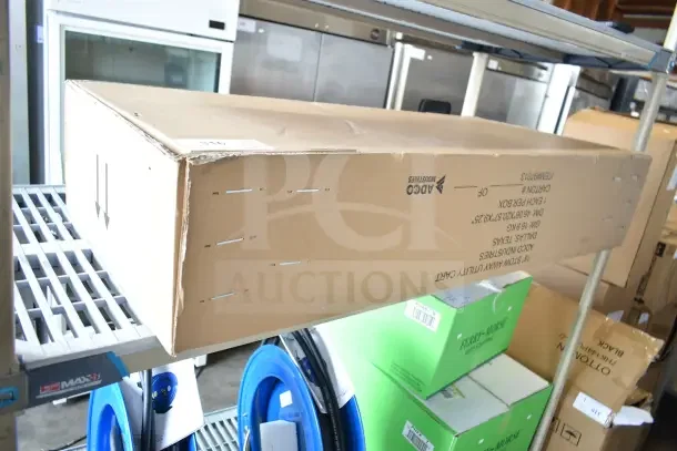 Brand new Adco 18" Stow Away Utility Cart in box, visible scratch, markings include dimensions and brand.