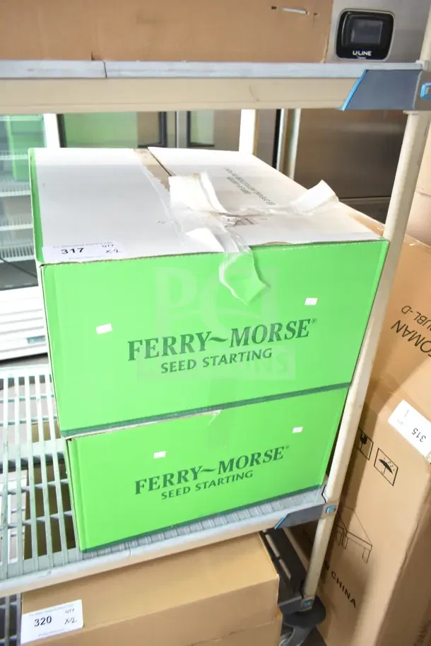 Two brand new Ferry Morse Seed Starter boxes marked "scratch and dent," stacked on metal shelving.