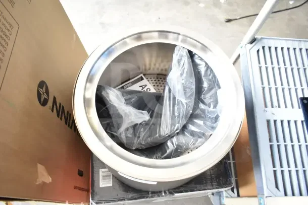 Coleman smokeless fire pit, brand new, scratch and dent, stainless steel, includes packaging and accessories.