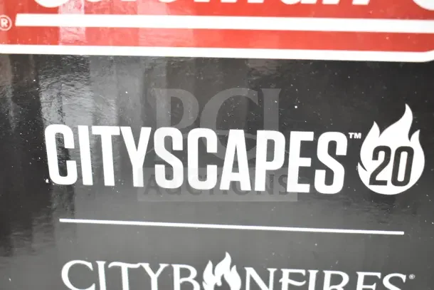 Alt text: "Coleman Cityscapes 20 Smokeless Fire Pit, brand new, with minor scratches and dents visible on packaging."