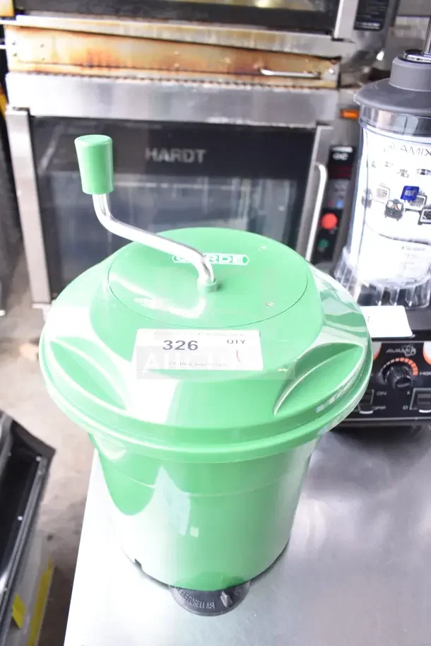 Green Garde Lettuce Spinner, brand new with minor scratches. Visible tag: "326 QTY 1". Manual handle, durable plastic.