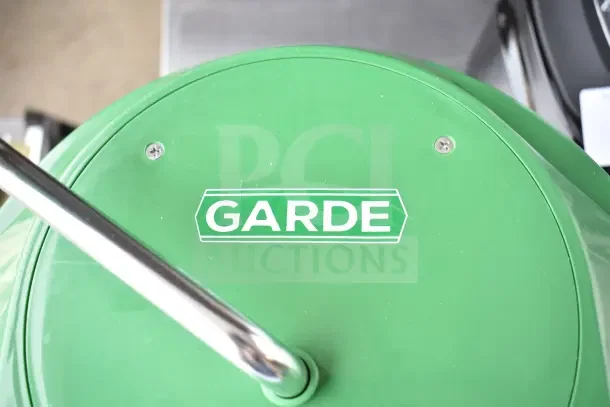 Green Garde Lettuce Spinner, brand new, with minor scratches and dents, features sturdy handle and visible logo.