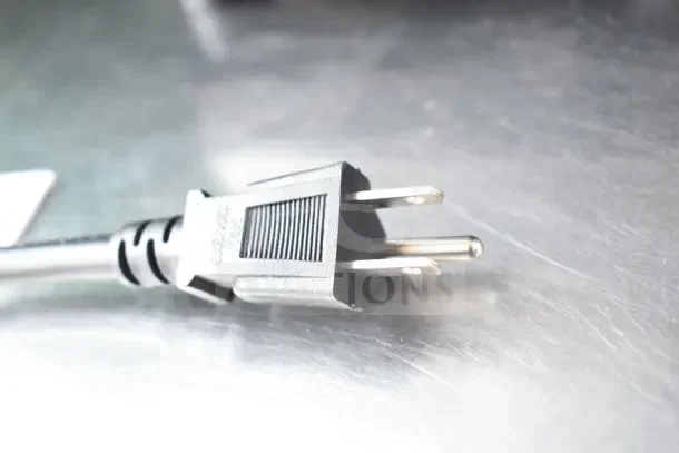 Close-up of a standard black electrical plug from the AvaMix 928BX2000V commercial blender, resting on a metallic surface.