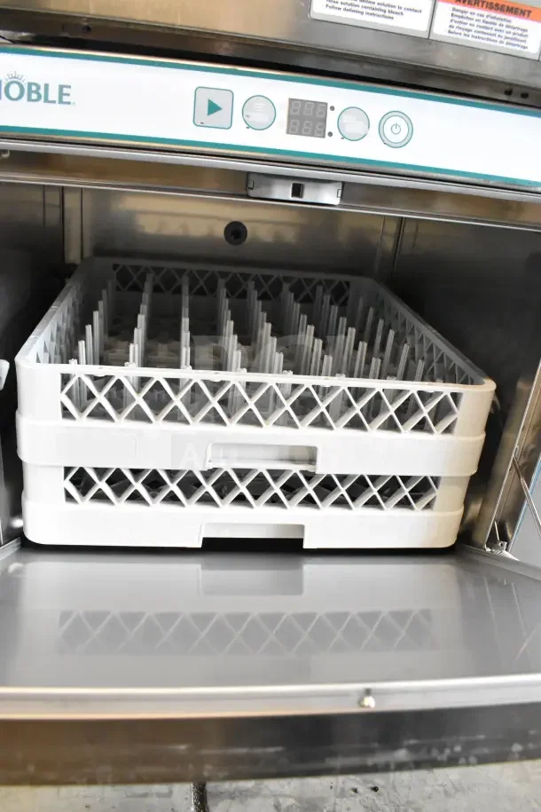Brand new Noble commercial undercounter dishwasher. Visible digital controls. Includes rack. Scratch and dent condition.