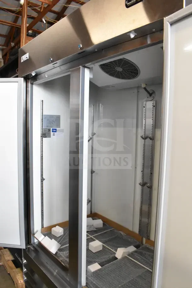 Brand new 2025 Avantco 178A49FHC commercial 2-door reach-in freezer, 115V, 1 phase, interior view, shelf brackets visible.