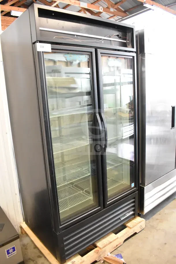 Brand new 2025 True GDM-35F-HC commercial 2-door freezer merchandiser, 115V, visible shelving, slight dents.