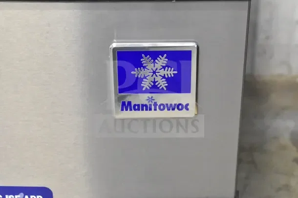 Manitowoc Ice Head, brand new with minor scratches. Features stainless steel exterior and prominent logo badge.