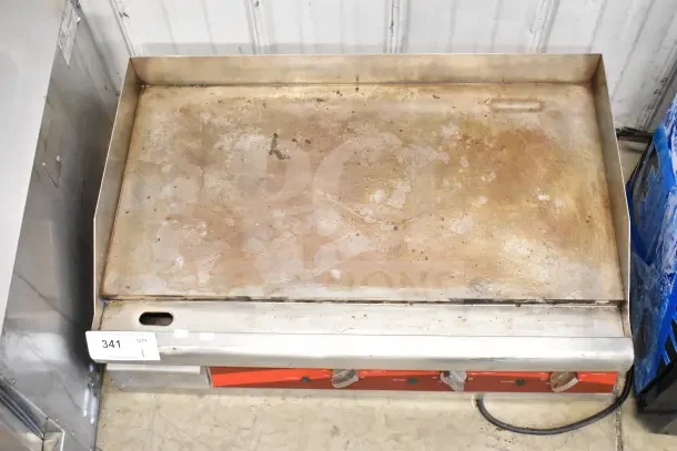 Avantco Commercial Countertop Flat Top Griddle; signs of use, front knobs, and side walls. Tag with number 341 attached.