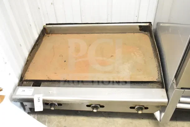 Radiance commercial countertop flat top griddle with three control knobs, showing wear. Ideal for restaurant use.