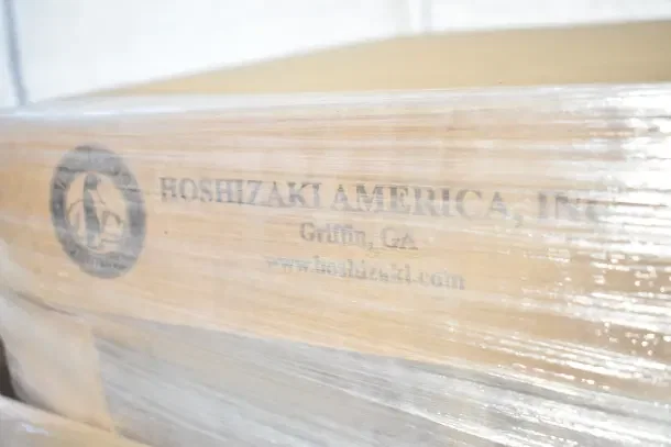 Brand new Hoshizaki DB-130H ice dispenser crate, 130 lbs capacity, stainless steel, scratch and dent condition. Marked "Hoshizaki America, Inc."