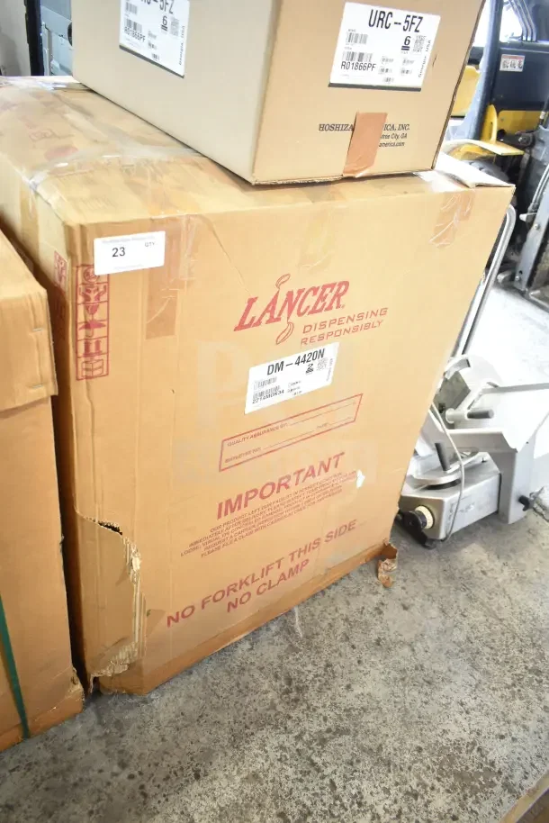 Lancer DM-4420N Ice and Water Dispenser in box with visible brand and model labels, showing some wear.
