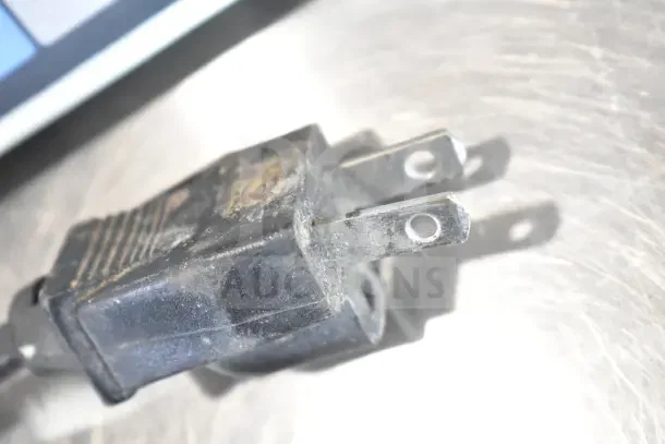 Globe GS130 countertop scale plug close-up, showing signs of wear and minor corrosion on the prongs.