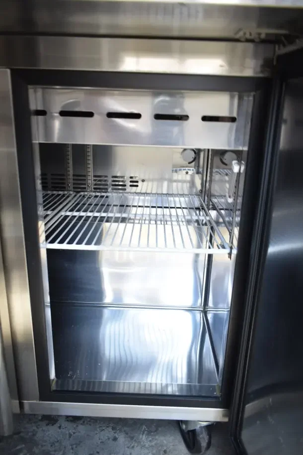 Norlake SMP36-15 prep table interior with wire shelves, stainless steel finish, visible commercial casters. Electric, 115V, 1 phase.