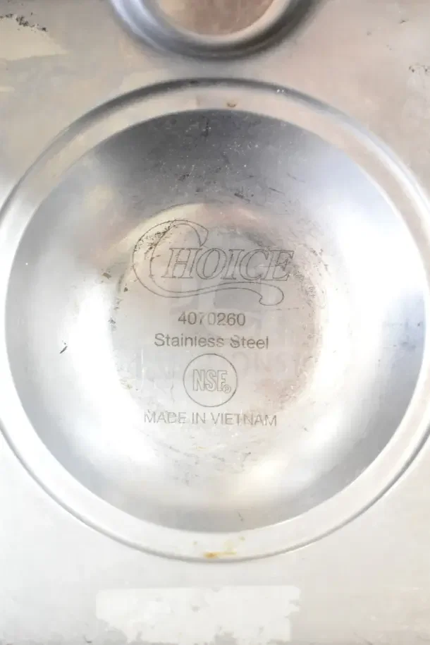 Stainless steel muffin pan by Choice, model 4070260, marked NSF, made in Vietnam. Slightly worn condition.