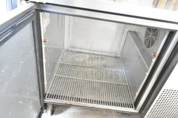 True TUC-44 undercounter cooler, commercial single door, 115 volts, 1 phase. Interior view shows shelving and fan.