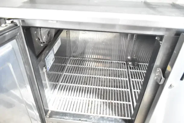 Everest ETWF2 2 Door Undercounter Commercial Freezer, 115V, 1 Phase, clean interior, visible racks, and fan.