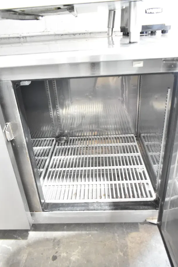 Everest ETWF2 commercial undercounter freezer, 2-door, 115V, 1-phase, stainless steel, interior shelves, good condition.