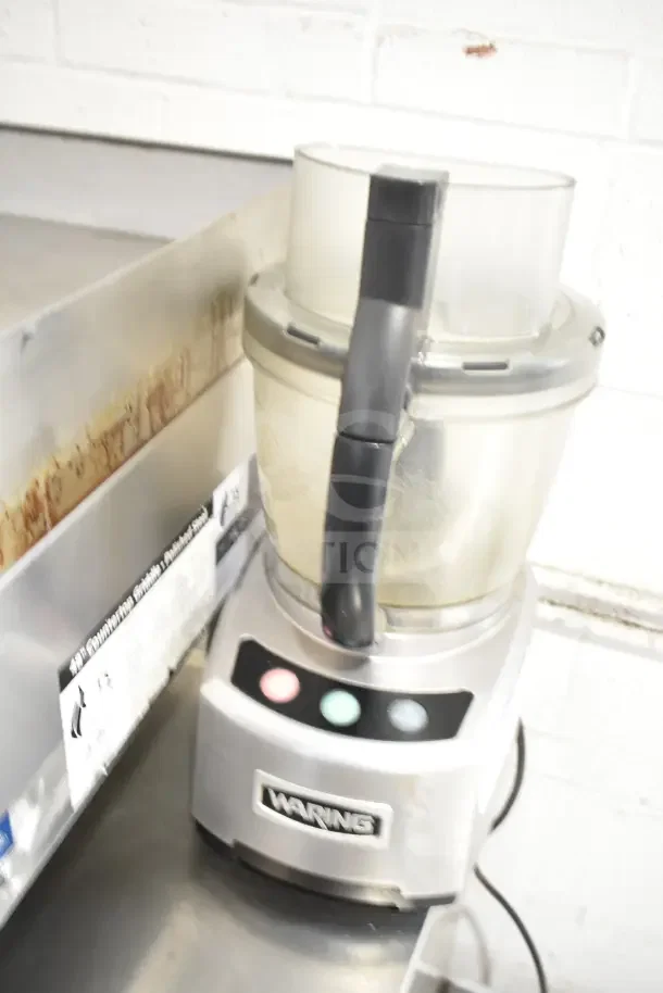 Waring countertop food processor, stainless steel, 120 volts, 1 phase, includes control panel with buttons.