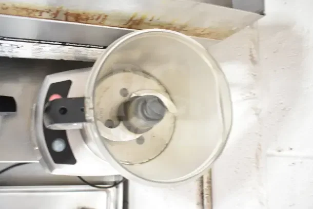 Waring countertop food processor, 120 volts, 1 phase, with a clear bowl and visible blade. Good condition.