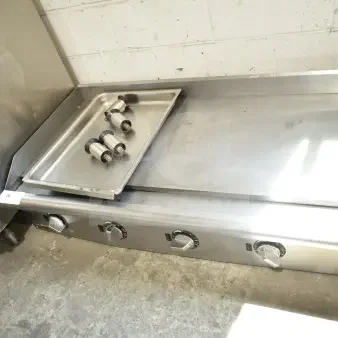 APW Wyott Commercial Countertop Flat Top Griddle with adjustable knobs, stainless steel, in used condition, includes drip tray.