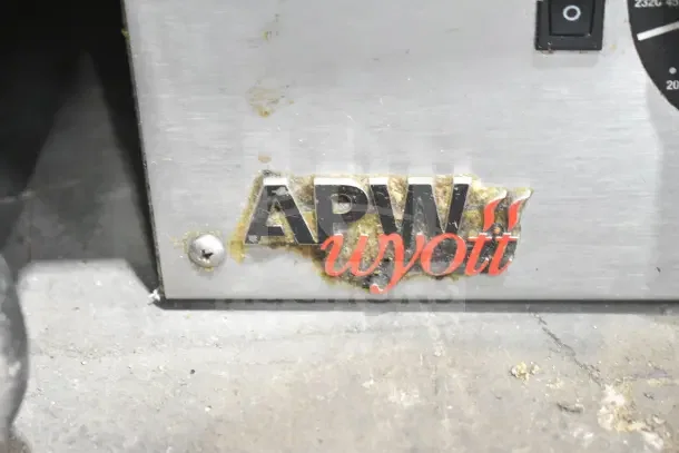 APW Wyott Commercial Countertop Flat Top Griddle, showing brand logo and power switch area, lightly soiled condition.