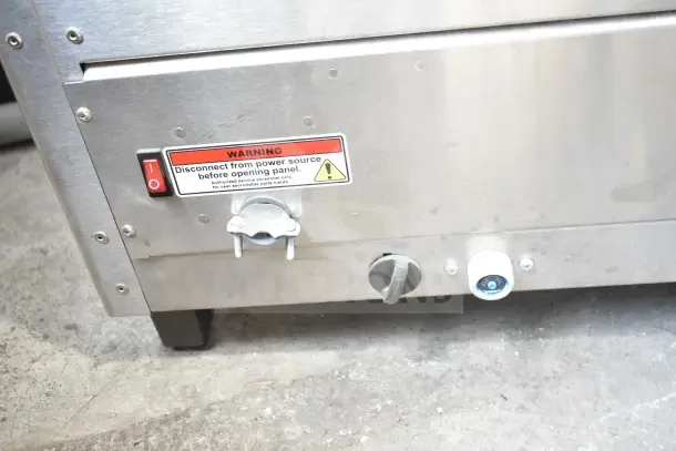 Fetco CBS-2132-XTS commercial coffee machine, stainless steel, warning label visible, 200-240V, 1 phase.
