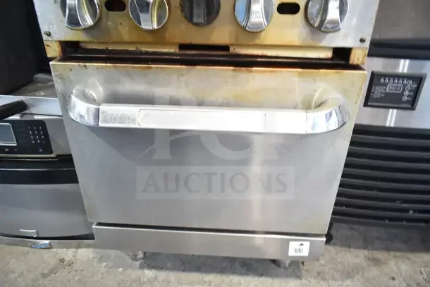 Commercial gas 4-burner range with oven, over-shelf, and backsplash. Stainless steel, visible wear on front, auction ID tag.