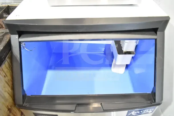 2024 Avantco 194UCF280A undercounter ice machine, 299 lb. capacity, 80 lb. bin, full cube, 115V, 1 phase, open bin view.